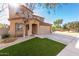 Two-story house with artificial turf, driveway, and attached garage at 17395 W Straight Arrow Ln, Surprise, AZ 85387
