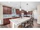 Spacious kitchen featuring granite countertops and dark wood cabinets at 17395 W Straight Arrow Ln, Surprise, AZ 85387