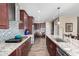 Modern kitchen with granite countertops, stainless steel appliances, and a tile backsplash at 17395 W Straight Arrow Ln, Surprise, AZ 85387