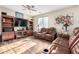 Relaxing living room with brown leather reclining sofas at 17395 W Straight Arrow Ln, Surprise, AZ 85387