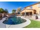 Relaxing backyard with a kidney-shaped pool, patio, and lush landscaping at 17395 W Straight Arrow Ln, Surprise, AZ 85387