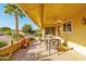 Covered patio with seating area, tile flooring, and desert landscaping at 17806 N 130Th Ave, Sun City West, AZ 85375