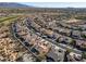 Community overview showcasing numerous homes, a golf course, and mountain views at 18088 W Narramore Rd, Goodyear, AZ 85338