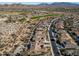 Aerial view of homes in a desert community near a golf course and mountains at 18088 W Narramore Rd, Goodyear, AZ 85338