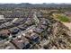 Aerial view of a residential area with golf course and mountain views at 18088 W Narramore Rd, Goodyear, AZ 85338