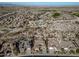 Aerial view of homes in a desert community near a golf course and mountains at 18088 W Narramore Rd, Goodyear, AZ 85338