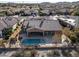 Aerial view of house, pool, and backyard, overlooking neighborhood at 18088 W Narramore Rd, Goodyear, AZ 85338