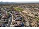 Aerial view of a residential neighborhood near a golf course and mountains at 18088 W Narramore Rd, Goodyear, AZ 85338