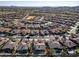 Community overview showcasing numerous homes, a golf course, and mountain views at 18088 W Narramore Rd, Goodyear, AZ 85338