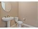 Clean bathroom with pedestal sink and updated toilet at 18088 W Narramore Rd, Goodyear, AZ 85338