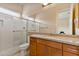 Modern bathroom with granite countertop, large shower and a toilet at 18088 W Narramore Rd, Goodyear, AZ 85338