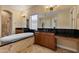 Elegant bathroom with double sinks, soaking tub, and walk-in shower at 18088 W Narramore Rd, Goodyear, AZ 85338