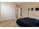 Spacious bedroom with double doors leading to the bathroom and a large closet at 18088 W Narramore Rd, Goodyear, AZ 85338