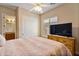 Cozy bedroom with a ceiling fan, large window, and built-in wooden dresser at 18088 W Narramore Rd, Goodyear, AZ 85338
