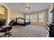 Large main bedroom with a king-size bed and access to the backyard at 18088 W Narramore Rd, Goodyear, AZ 85338