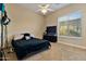 Bright bedroom with a large window, ceiling fan, and plenty of space for furniture at 18088 W Narramore Rd, Goodyear, AZ 85338