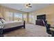 Spacious main bedroom with backyard access, a large TV, and a dresser at 18088 W Narramore Rd, Goodyear, AZ 85338
