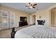 Comfortable main bedroom with backyard access, a large TV, and a home office area at 18088 W Narramore Rd, Goodyear, AZ 85338