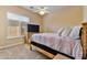 Well-lit bedroom featuring a wooden bed frame and large window at 18088 W Narramore Rd, Goodyear, AZ 85338