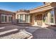 Private courtyard entrance with brick pavers and arched windows at 18088 W Narramore Rd, Goodyear, AZ 85338
