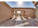 Inviting courtyard entry with brick pavers and wrought iron gate at 18088 W Narramore Rd, Goodyear, AZ 85338