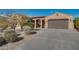 Single-story home with desert landscaping and a two-car garage at 18088 W Narramore Rd, Goodyear, AZ 85338
