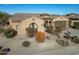 Single-story home with tile roof, desert landscaping, and a two-car garage at 18088 W Narramore Rd, Goodyear, AZ 85338