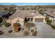 Single-story home with tile roof, desert landscaping, and a two-car garage at 18088 W Narramore Rd, Goodyear, AZ 85338