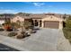 Single-story home with tile roof, desert landscaping, and a two-car garage at 18088 W Narramore Rd, Goodyear, AZ 85338