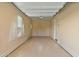 Clean and spacious garage with an arched window at 18088 W Narramore Rd, Goodyear, AZ 85338