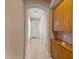 Elegant hallway featuring tile floors and built-in shelving at 18088 W Narramore Rd, Goodyear, AZ 85338
