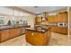Spacious kitchen with island, stainless steel appliances, and wood cabinets at 18088 W Narramore Rd, Goodyear, AZ 85338
