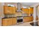 Bright kitchen with stainless steel appliances and wood cabinets at 18088 W Narramore Rd, Goodyear, AZ 85338
