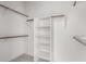 Spacious walk-in closet with built-in shelves and hanging rods at 25231 W Blue Sky Dr, Wittmann, AZ 85361