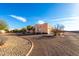 One-story stucco home with landscaped yard and driveway, desert setting at 25231 W Blue Sky Dr, Wittmann, AZ 85361