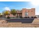 One-story stucco home with landscaped yard, driveway and desert setting at 25231 W Blue Sky Dr, Wittmann, AZ 85361