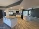 Modern kitchen with white cabinets, granite countertops, and a large island at 3547 W Redfield Rd, Phoenix, AZ 85053