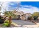 Tan house with brown garage door and palm trees in front at 4277 E Blue Sage Ct, Gilbert, AZ 85297