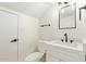 Modern bathroom with white vanity, quartz countertop, and black fixtures at 7430 N 43Rd Dr, Glendale, AZ 85301