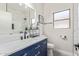 Stylish bathroom with navy vanity and marble shower at 7913 W Chickasaw St, Phoenix, AZ 85043