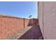 Side yard with gravel and brick wall at 11100 W Magdalena Dr, Arizona City, AZ 85123
