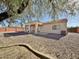 Landscaped backyard with gravel and a covered patio at 11100 W Magdalena Dr, Arizona City, AZ 85123