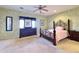 Bedroom with carpeted floor, ceiling fan, and an ornate bed frame at 11100 W Magdalena Dr, Arizona City, AZ 85123
