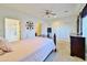 Bright bedroom with ensuite bathroom access and ceiling fan at 11100 W Magdalena Dr, Arizona City, AZ 85123