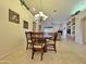 Dining area with a round table and chairs, open to the living room and kitchen at 11100 W Magdalena Dr, Arizona City, AZ 85123