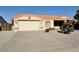 House exterior showcasing a two-car garage and neatly landscaped front yard at 11100 W Magdalena Dr, Arizona City, AZ 85123