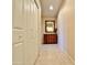 Hallway with tile flooring, built-in dresser, and mirrored wall at 11100 W Magdalena Dr, Arizona City, AZ 85123