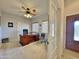 Home office features built-in desk, ceiling fan, and access to the main hallway at 11100 W Magdalena Dr, Arizona City, AZ 85123