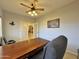 Home office with a large desk, view into another room, and ceiling fan at 11100 W Magdalena Dr, Arizona City, AZ 85123