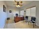 Bright home office with a large desk, two chairs, and ceiling fan at 11100 W Magdalena Dr, Arizona City, AZ 85123